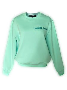 his oversized Bowery sweatshirt is design with a unisex fit and sizing (Suitable for Men and Women) This piece with super soft cotton and vibrant color, will definitely make you stand out from the crowd. *Imported 100% cotton fleece with ribbed cuffs and hem * Aqua Green Vibrant color *Satin Teal Blue Lacquer Passion embroidery in front of the garment. Lacquer Passion. Front view.